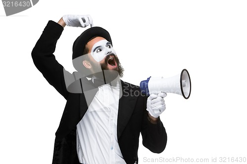 Image of Man with a face mime screaming into megaphone 