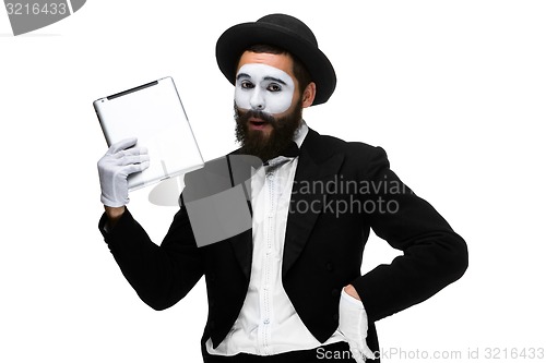 Image of Man with a face mime working on a laptop isolated on a white background. 