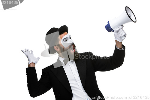 Image of Man with a face mime screaming into megaphone 