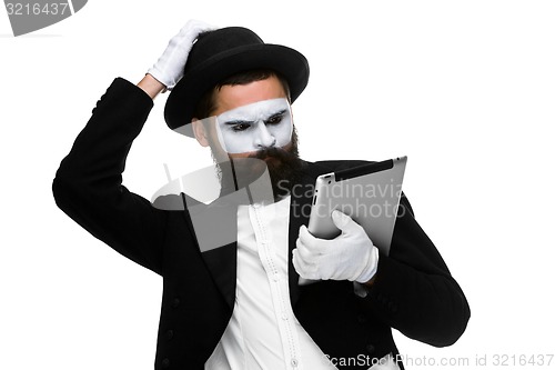 Image of Man with a face mime working on laptop 