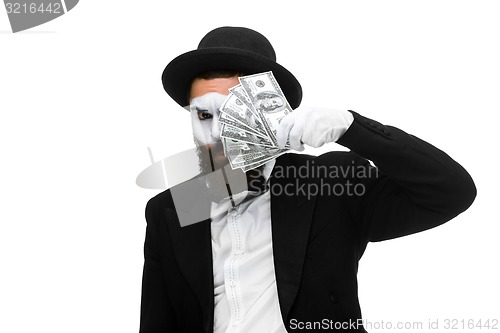 Image of mime as businessman holding money