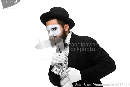 Image of mime as businessman putting money in his pocket