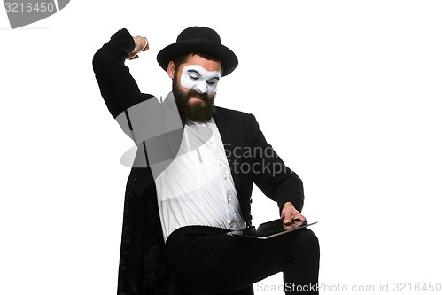 Image of Mime as businessman has stress because of computer problem. 