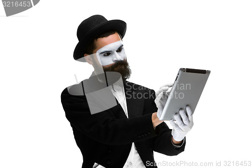 Image of Man with a face mime working ona laptop 