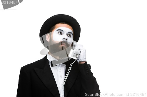 Image of man in the image mime holding a handset. 