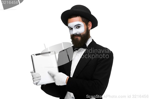 Image of Man with a face mime working on laptop 