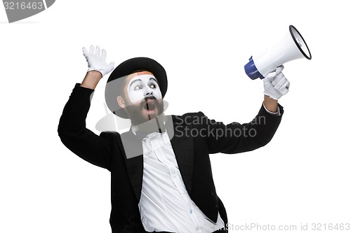 Image of Man with a face mime screaming into megaphone 