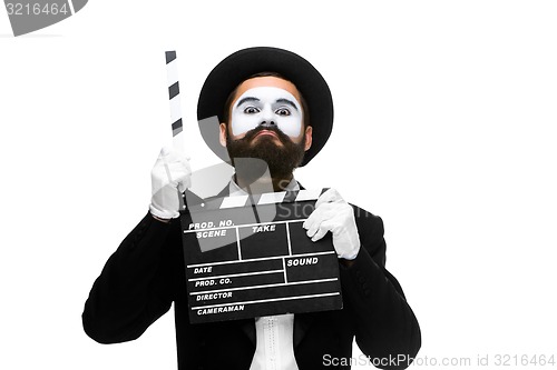 Image of man in the image mime with movie board