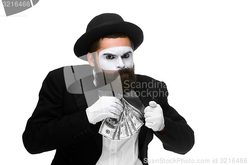 Image of mime as businessman putting money in his pocket