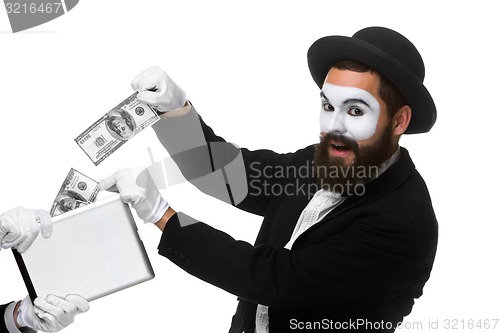 Image of businessman\'s hand in the form of mime extract money from tablet PC