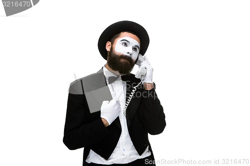 Image of man in the image mime holding a handset. 