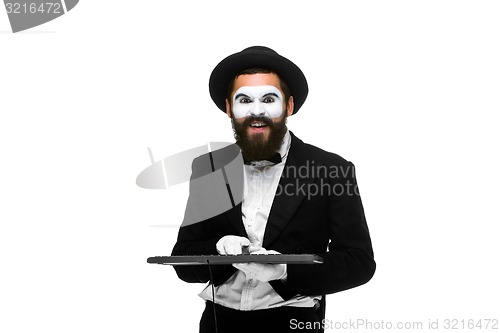 Image of mime as a businessman holdinga keyboard