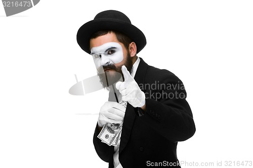 Image of mime as businessman putting money in his pocket