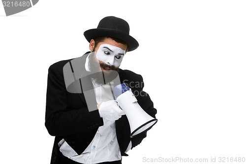 Image of Man with a face mime screaming into megaphone 