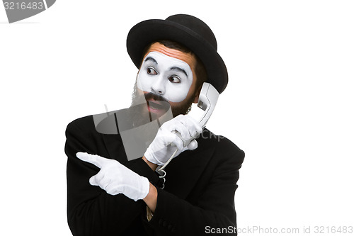 Image of man in the image mime holding a handset. 