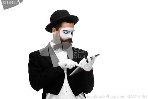 Image of Man with a face mime working on laptop 