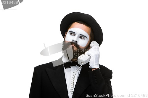 Image of man in the image mime holding a handset. 