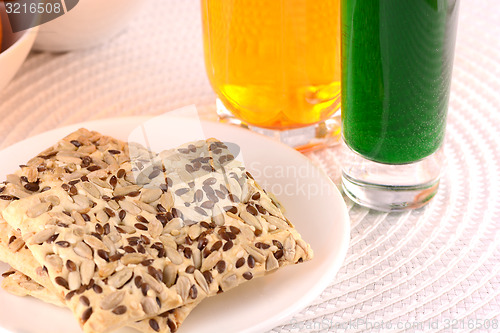 Image of sweet cake on white plate with fresh juice