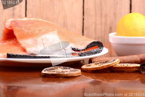 Image of Slice of red fish salmon with fruits and cinnamon