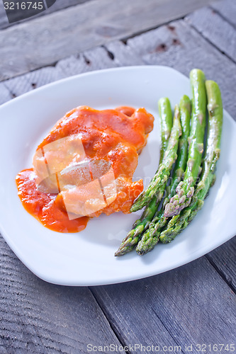 Image of fried meat with sauce and asparagus