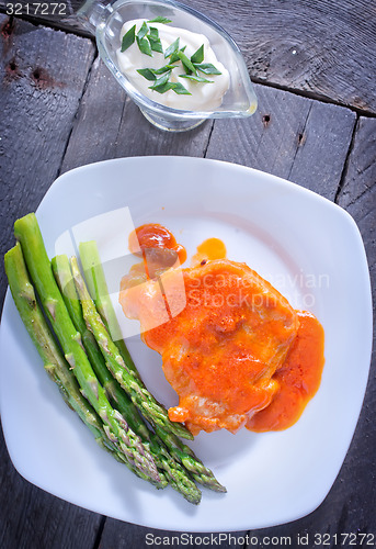 Image of fried meat with sauce and asparagus