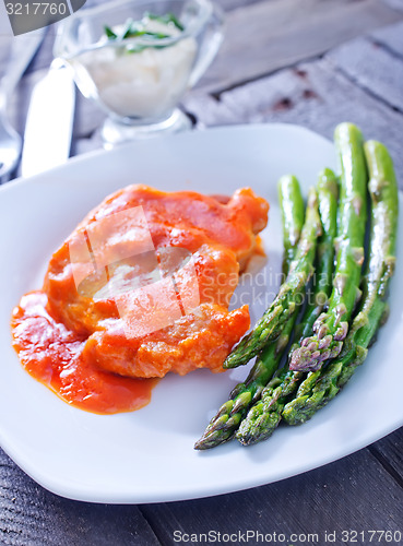 Image of fried meat with sauce and asparagus