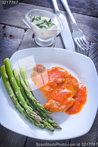 Image of fried meat with sauce and asparagus