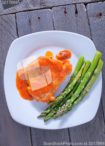 Image of fried meat with sauce and asparagus