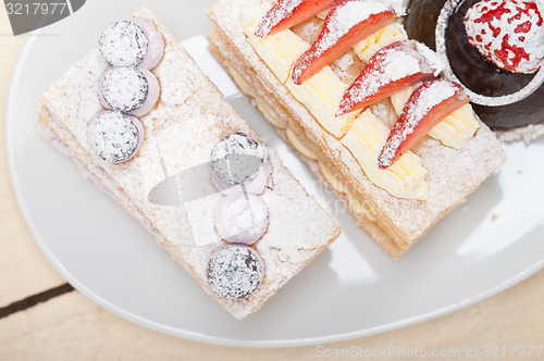 Image of selection of fresh cream cake dessert plate 