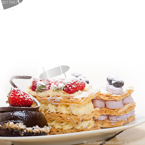 Image of selection of fresh cream cake dessert plate 