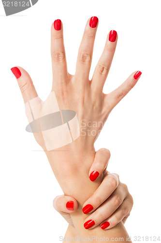 Image of Woman with beautiful manicured red fingernails