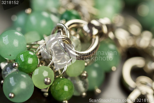 Image of Green beads on an item of silver jewellery