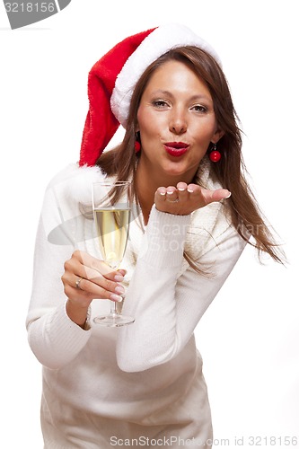 Image of Playful woman celebrating Xmas blowing a kiss