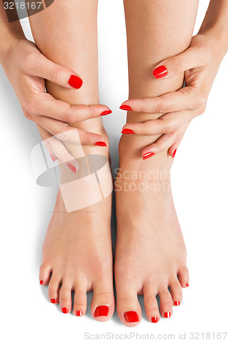 Image of Woman with beautiful red finger and toenails