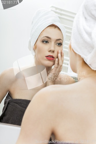 Image of Woman From Shower Looking her Face at the Mirror