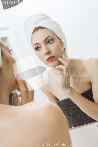 Image of Woman From Shower Looking her Face at the Mirror