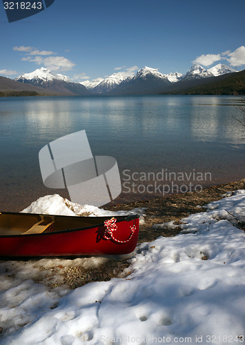 Image of Red Canoe Fresh Snow Lake McDonald Glacier National Park Montana