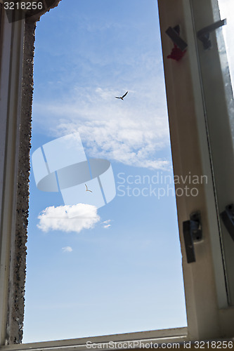 Image of Blue cloudy sky in window