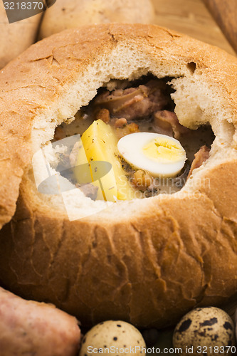 Image of traditional white borscht (zurek) with sausage,egg and mushrooms