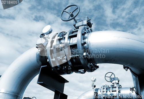 Image of Industrial zone, Steel pipelines and valves against blue sky