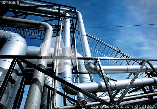 Image of Industrial zone, Steel pipelines and valves against blue sky