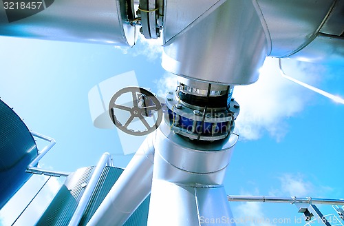 Image of Industrial zone, Steel pipelines and valves against blue sky