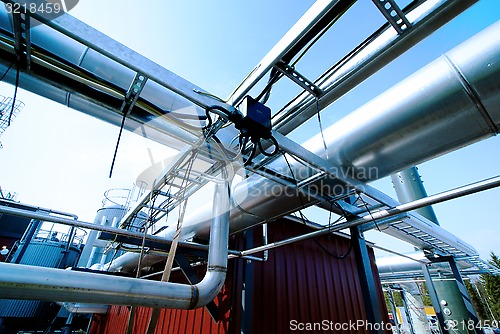 Image of Industrial zone, Steel pipelines and valves against blue sky