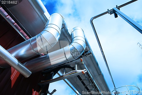 Image of Industrial zone, Steel pipelines and valves against blue sky