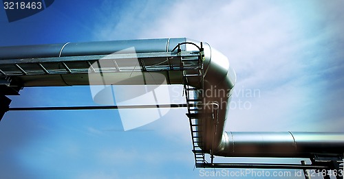 Image of Industrial zone, Steel pipelines and valves against blue sky