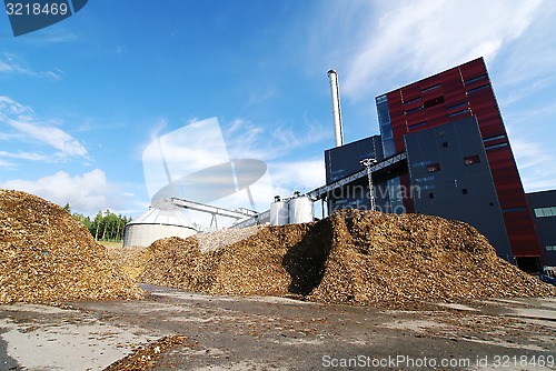 Image of bio power plant with storage of wooden fuel (biomass) against bl