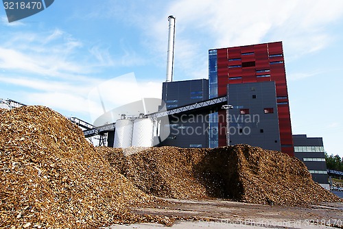 Image of bio power plant with storage of wooden fuel (biomass) against bl