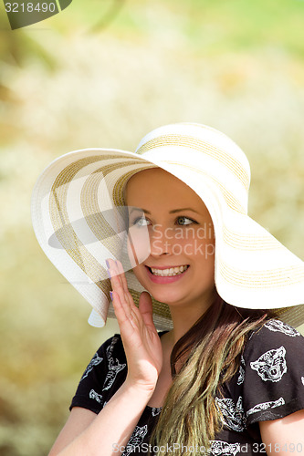 Image of Cheerful fashionable woman in stylish hat and frock posing