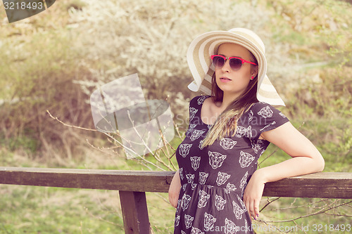 Image of Cheerful fashionable woman in stylish hat, frock and sunglasses
