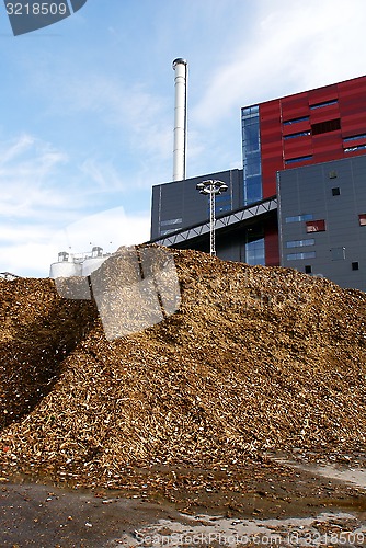 Image of bio power plant with storage of wooden fuel (biomass) against bl